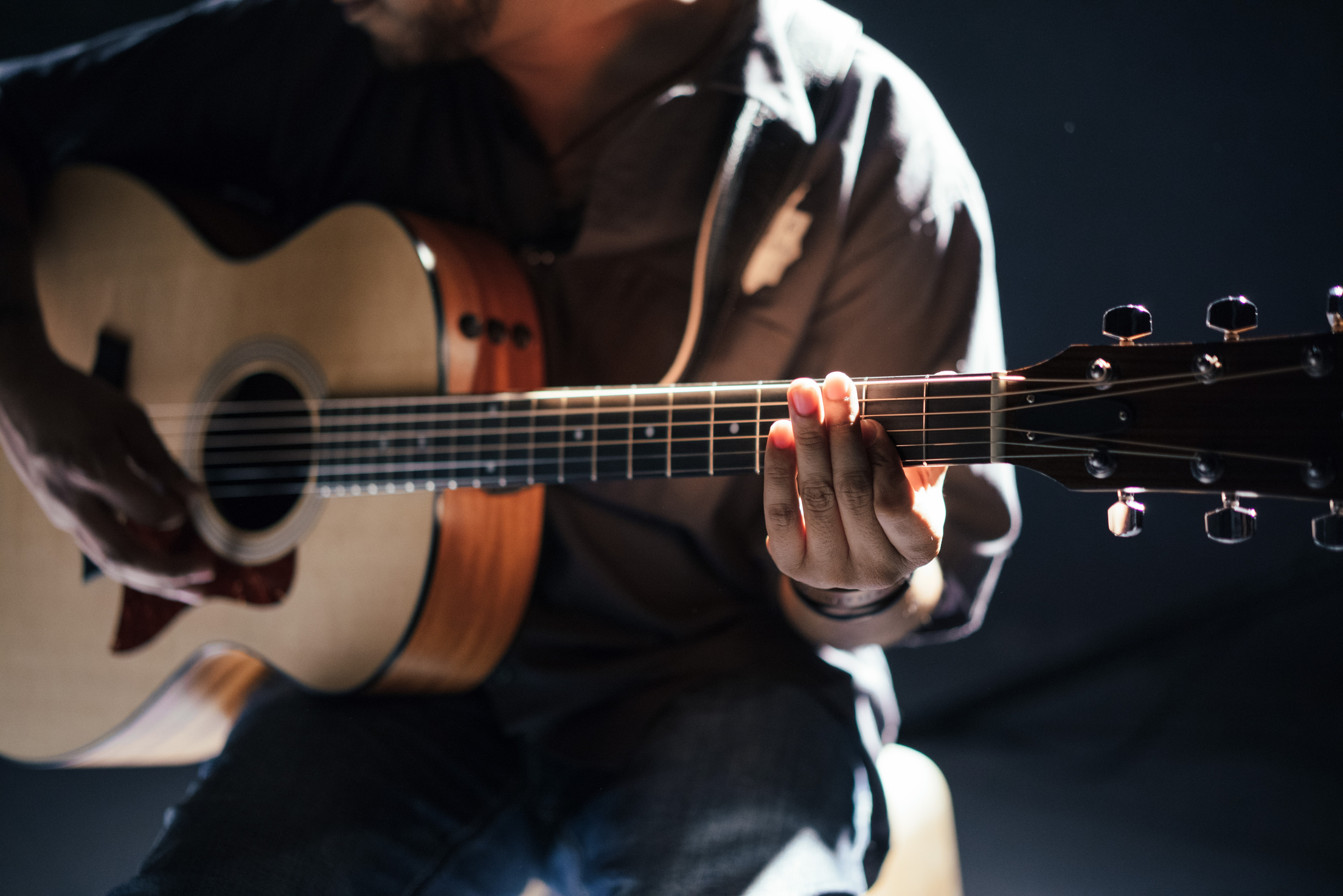 Artist Playing a Guitar